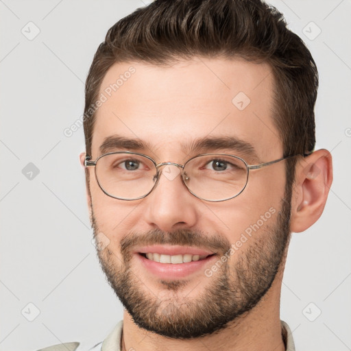 Joyful white young-adult male with short  brown hair and brown eyes