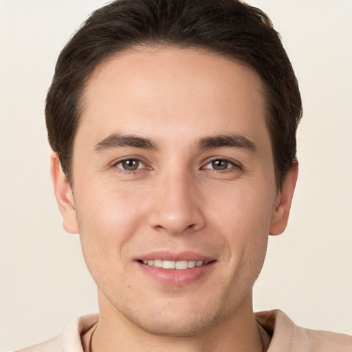 Joyful white young-adult male with short  brown hair and brown eyes