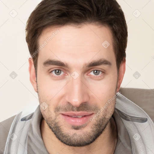 Joyful white young-adult male with short  brown hair and brown eyes