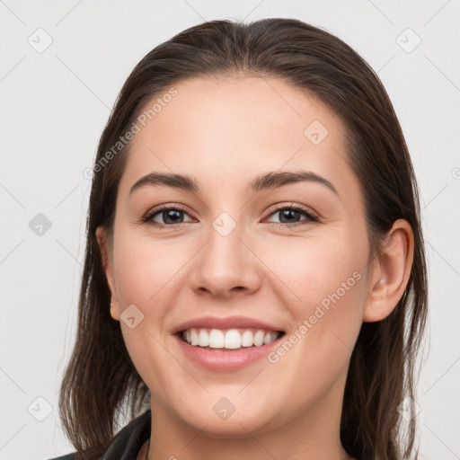 Joyful white young-adult female with medium  brown hair and grey eyes