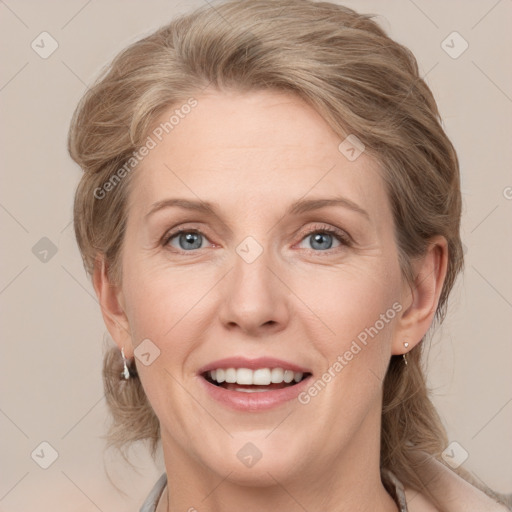 Joyful white adult female with medium  brown hair and grey eyes