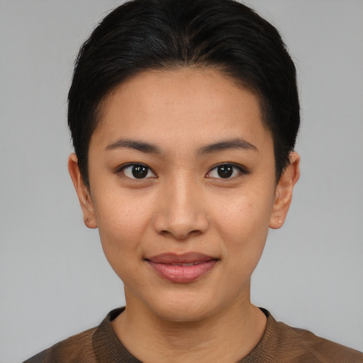 Joyful asian young-adult female with short  brown hair and brown eyes