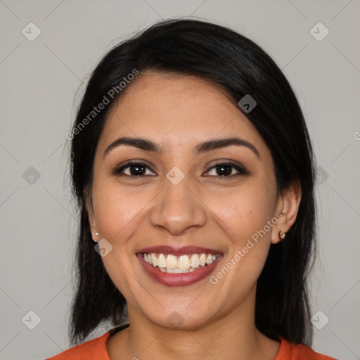 Joyful latino young-adult female with long  black hair and brown eyes