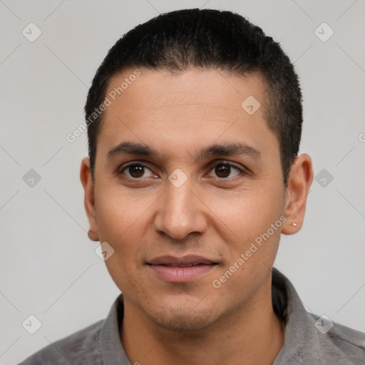 Joyful latino young-adult male with short  black hair and brown eyes