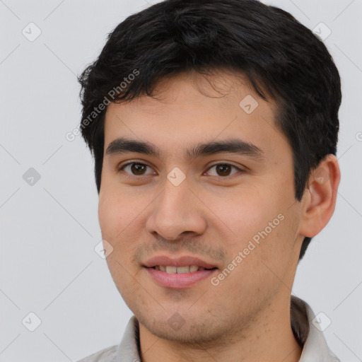 Joyful white young-adult male with short  black hair and brown eyes