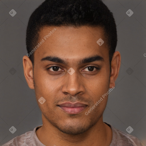 Joyful black young-adult male with short  brown hair and brown eyes