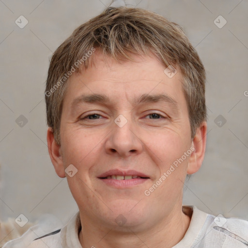 Joyful white adult male with short  brown hair and grey eyes