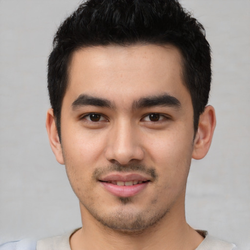 Joyful latino young-adult male with short  black hair and brown eyes