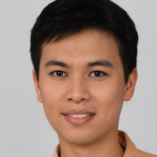 Joyful asian young-adult male with short  brown hair and brown eyes