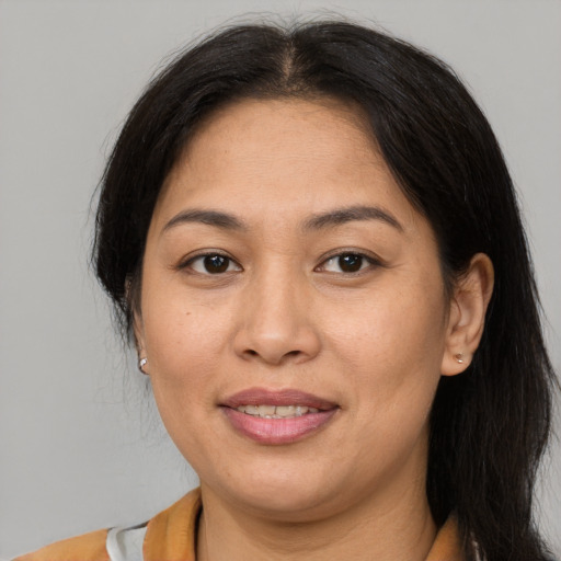 Joyful asian adult female with medium  brown hair and brown eyes