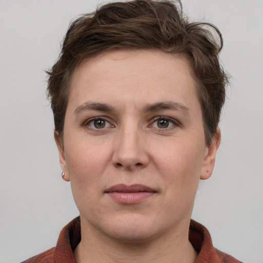 Joyful white adult female with short  brown hair and grey eyes