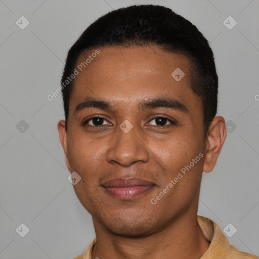 Joyful black young-adult male with short  black hair and brown eyes