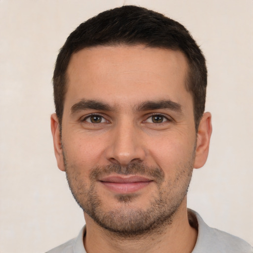 Joyful white young-adult male with short  brown hair and brown eyes