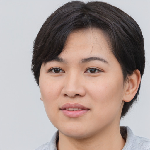 Joyful asian young-adult female with medium  black hair and brown eyes