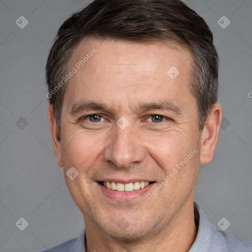 Joyful white adult male with short  brown hair and brown eyes