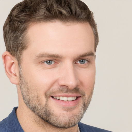 Joyful white adult male with short  brown hair and brown eyes