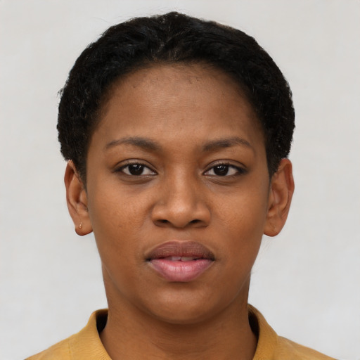 Joyful black young-adult female with short  black hair and brown eyes