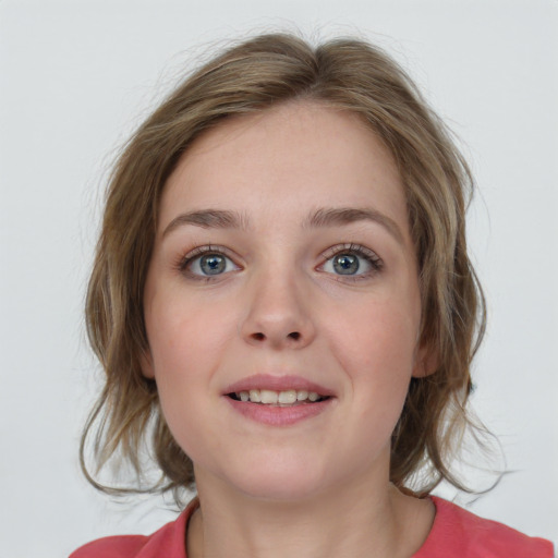 Joyful white young-adult female with medium  brown hair and blue eyes