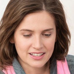 Joyful white young-adult female with medium  brown hair and blue eyes