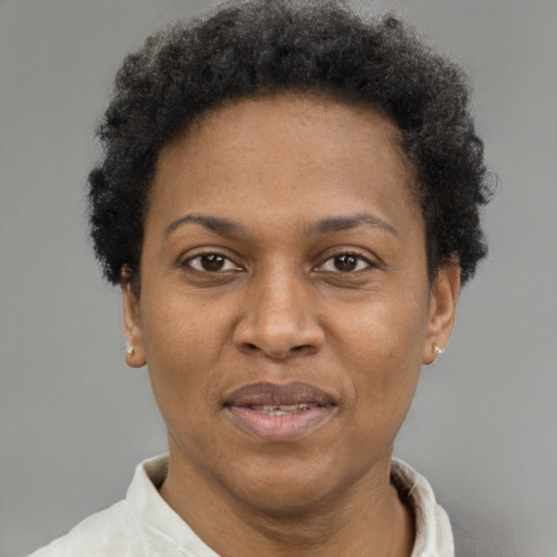 Joyful black adult female with short  brown hair and brown eyes