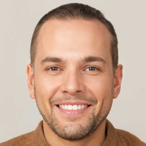 Joyful white young-adult male with short  brown hair and brown eyes