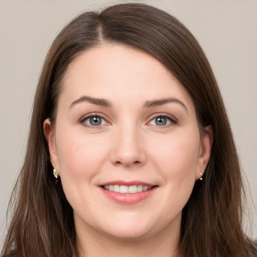 Joyful white young-adult female with long  brown hair and grey eyes