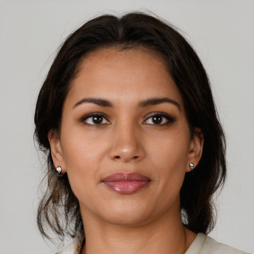 Joyful latino young-adult female with medium  brown hair and brown eyes