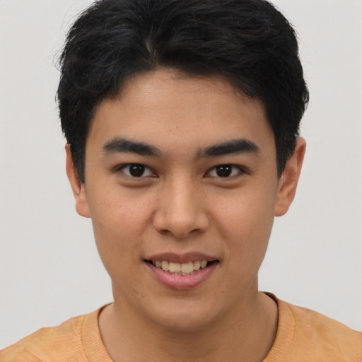 Joyful asian young-adult male with short  brown hair and brown eyes