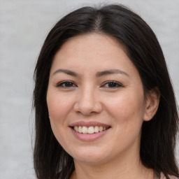 Joyful asian young-adult female with long  brown hair and brown eyes