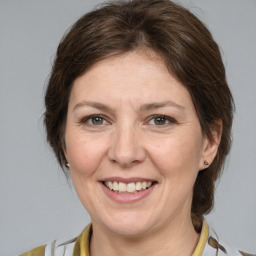 Joyful white adult female with medium  brown hair and brown eyes