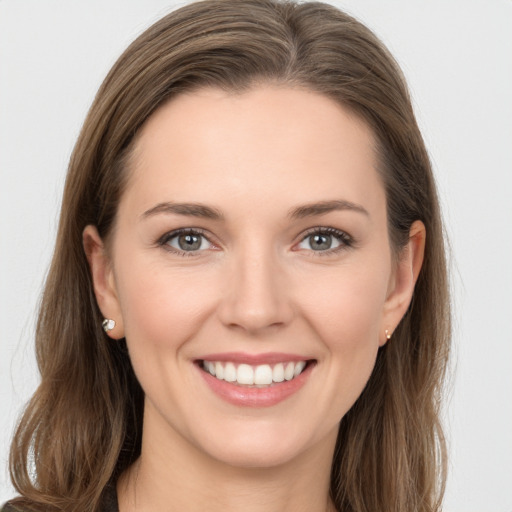 Joyful white young-adult female with long  brown hair and brown eyes