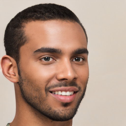 Joyful latino young-adult male with short  brown hair and brown eyes