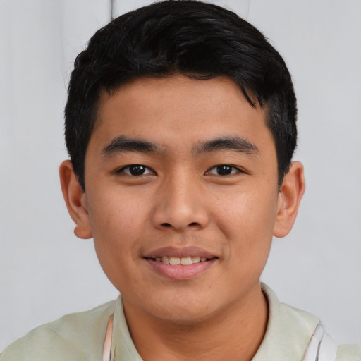 Joyful asian young-adult male with short  black hair and brown eyes