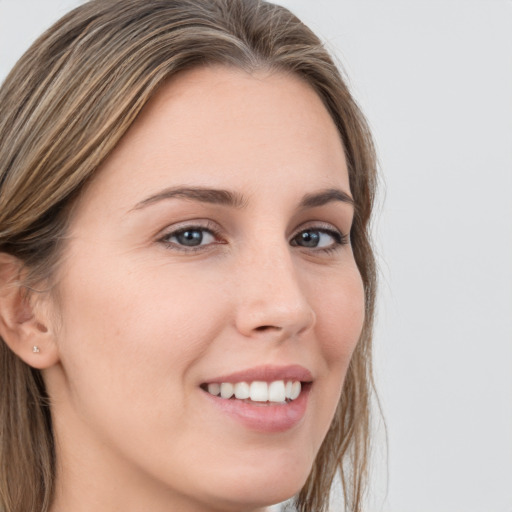 Joyful white young-adult female with long  brown hair and grey eyes