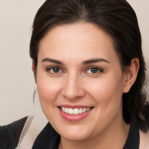 Joyful white young-adult female with medium  brown hair and brown eyes