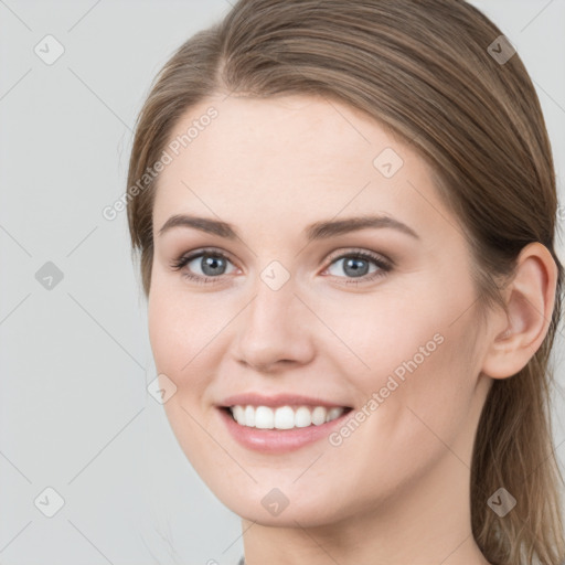 Joyful white young-adult female with long  brown hair and grey eyes