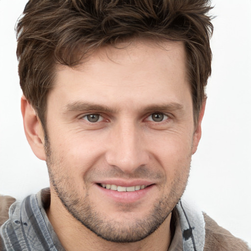 Joyful white adult male with short  brown hair and brown eyes