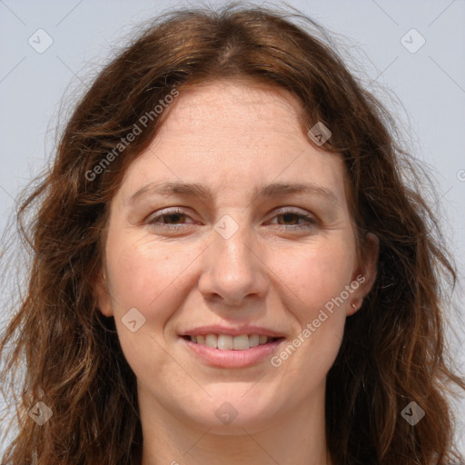 Joyful white adult female with long  brown hair and green eyes