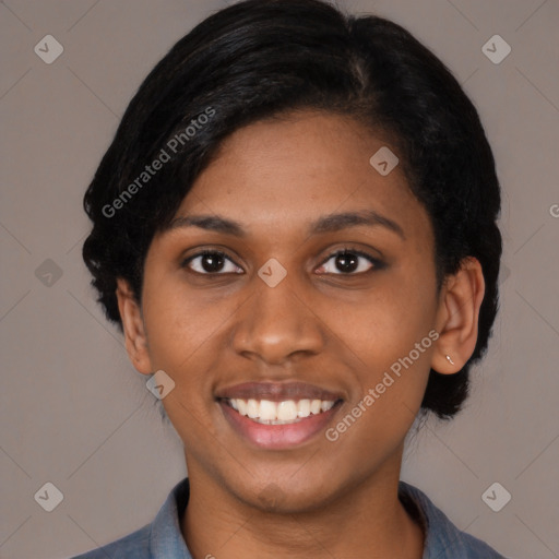 Joyful black young-adult female with medium  black hair and brown eyes