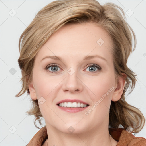 Joyful white young-adult female with medium  brown hair and blue eyes