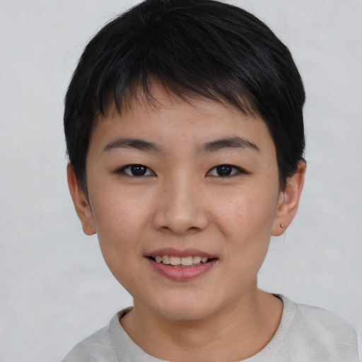 Joyful asian child female with short  brown hair and brown eyes