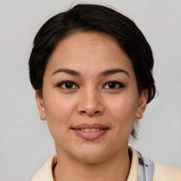 Joyful asian young-adult female with medium  brown hair and brown eyes