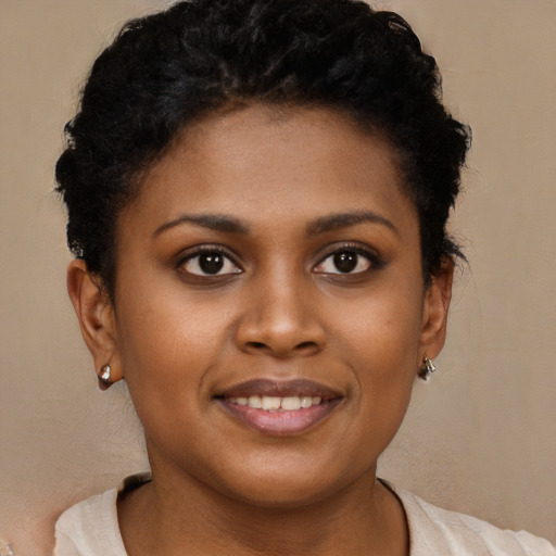 Joyful black young-adult female with short  brown hair and brown eyes