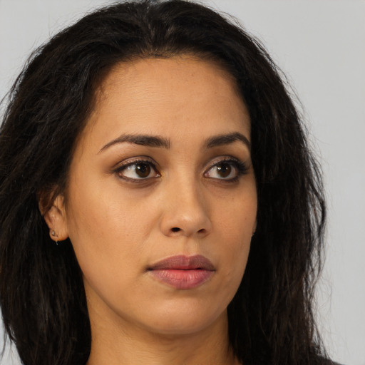 Neutral latino young-adult female with long  brown hair and brown eyes
