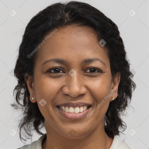 Joyful black adult female with medium  brown hair and brown eyes