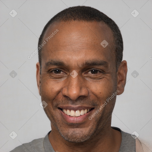 Joyful black adult male with short  black hair and brown eyes