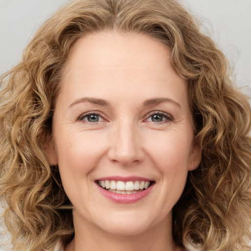 Joyful white young-adult female with medium  brown hair and green eyes