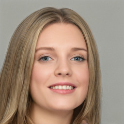 Joyful white young-adult female with long  brown hair and green eyes