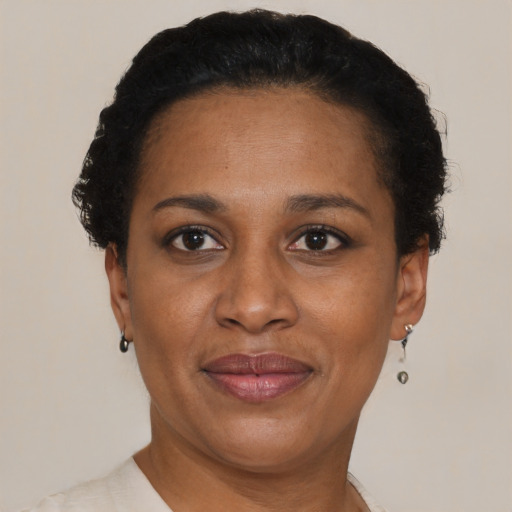 Joyful black adult female with short  brown hair and brown eyes
