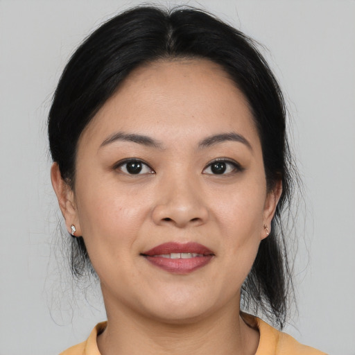 Joyful asian young-adult female with medium  brown hair and brown eyes